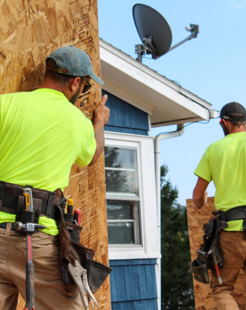 Men Constructing Home Addition: Woodwork in Progress